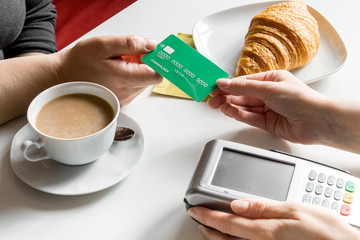 Credit card payment in cafe on white table background