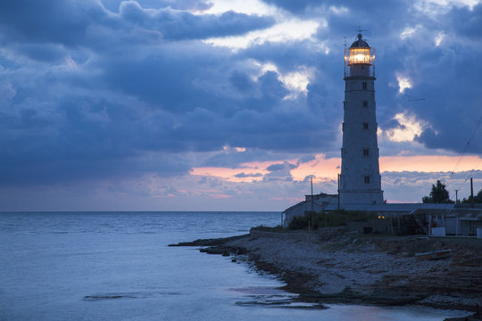 blue twilights around old lighthouse on the sea coast