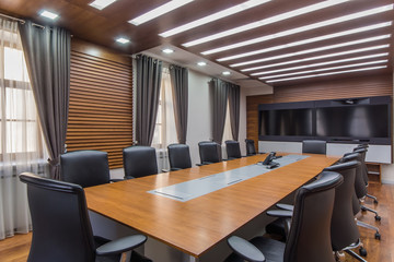 Interior of a modern office meeting room with wide screen TV