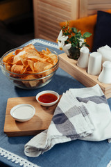 Potato chips with sauce on the table. Homemade sauces