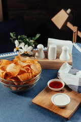 Potato chips with sauce on the table. Homemade sauces