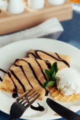 Pancakes with ice cream and chocolate sauce.