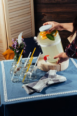 party drink station with small bottles and homemade lemonade