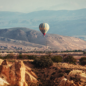 Colorful hot air balloons flying over Red valley at Cappadocia, 