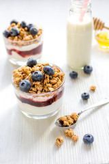 Fitness breakfast with muesli, honey and milk on white table