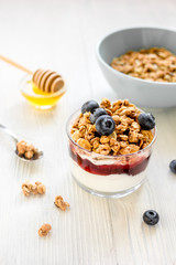 Healthy morning with granola breakfast on white kitchen table