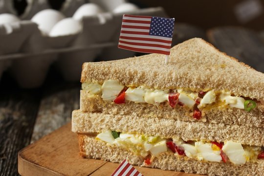 Mayo egg sandwich with american flag on top, selective focus