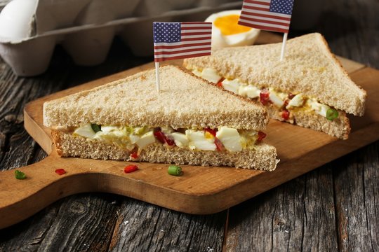 Mayonnaise egg sandwich with American flag on top, selective focus