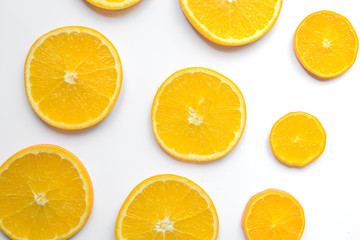 Obraz premium slices of oranges on white background bright pattern top view