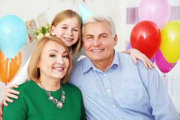 Grandparents with their grandchild at  birthday party © Africa Studio