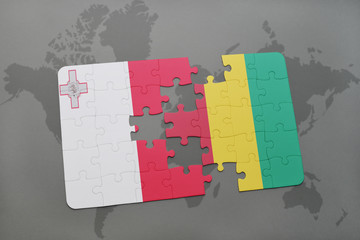 puzzle with the national flag of malta and guinea on a world map