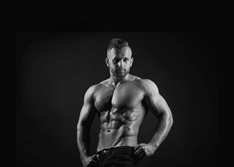Attractive sporty handsome sexy muscular young adult male fitness model in black and white portrait