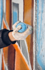 Boy painting graffiti close-up in high quality