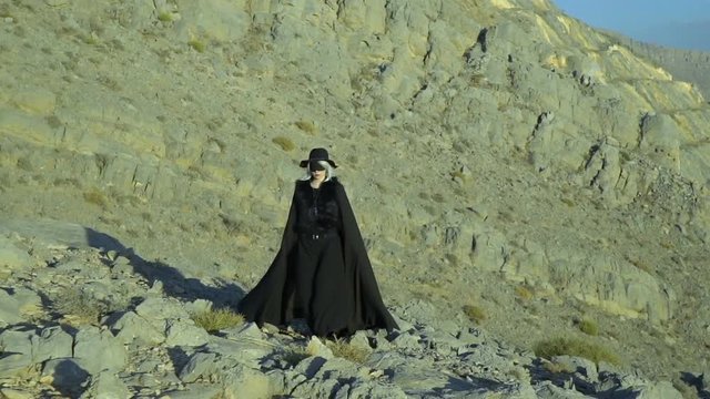 Dark beautiful lady in the mountains