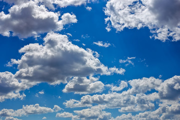 Obraz na płótnie Canvas Blue sky background with fluffy clouds