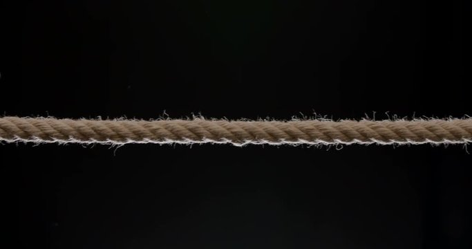 Medium shot of rope being pulled across the frame