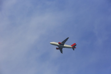 Fototapeta na wymiar Airplane flying in the sky