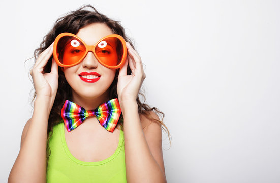 young funny woman with big orange sunglasses