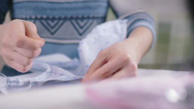 Close-up of woman's hand stitching quilting
