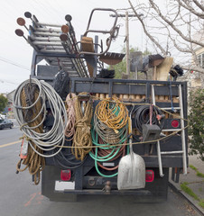 Rear view of truck's neatly arranged maintenance equipment.