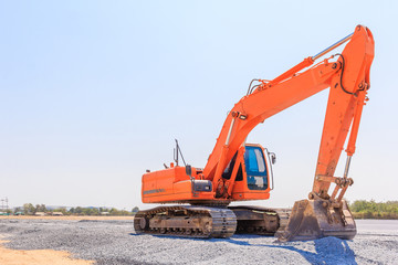 Excavators machine on a construction site on a construction site against blue sky background