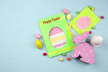 Easter concept. Greeting cards with wooden bunny on light background