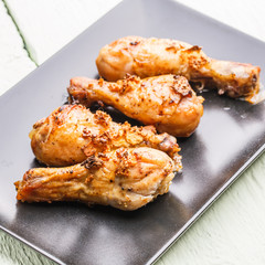 Roasted bird on black plate