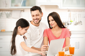 Happy parents and daughter on kitchen