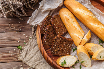 Baguette, bread in wooden saucer