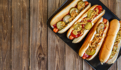 American hot dog with pickles,onions, ketchup and mustard