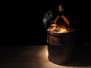 Obraz na płótnie Canvas Glass of Cognac , Cigar and old oak barrel