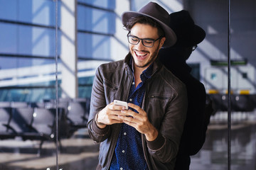 Traveler on an airport with smartphone