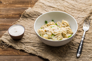 Meat dumplings - russian pelmeni, ravioli with meat on a white plate