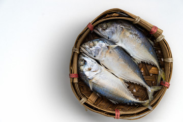 Mackerel fishes in bamboo basket white background