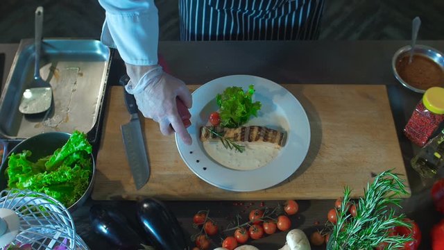 Chef Add's Sauce To Grilled Fish with Roasted Potatoes and Vegetables