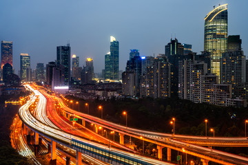 Fototapeta premium light trails on city street with cityscape at night in China.