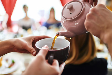 The tea is poured into the cup.