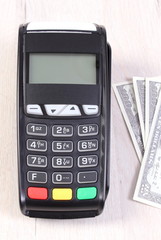 Obraz premium Payment terminal, credit card reader with currencies dollar, cashless paying for shopping or products