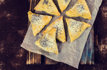 Triangular cookies with poppy seeds