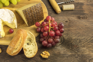 Wine and cheese tasting with bread, grapes and cork