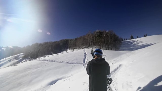 Footage of snowboarder man adventure, walking to snowy alps mountains