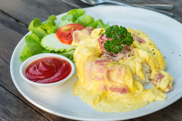 Omelet with bacon and rice on plate