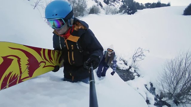 Footage of snowboarders man and girl adventure at mountain backcountry.