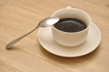 A cup of coffee on the wooden table