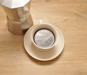 A cup of coffee on the wooden table