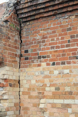 cracked old building brick wall with eroded bricks