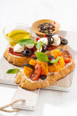 italian appetizer - bruschetta on wooden board, closeup