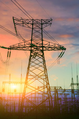 Sun setting over an electrical substation.