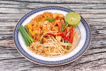 Popular Thai fried noodle call Pad Tai on Thai-pattern dish.