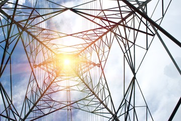 electricity transmission pylon silhouetted against blue sky.High-voltage power transmission towers in sunset sky background